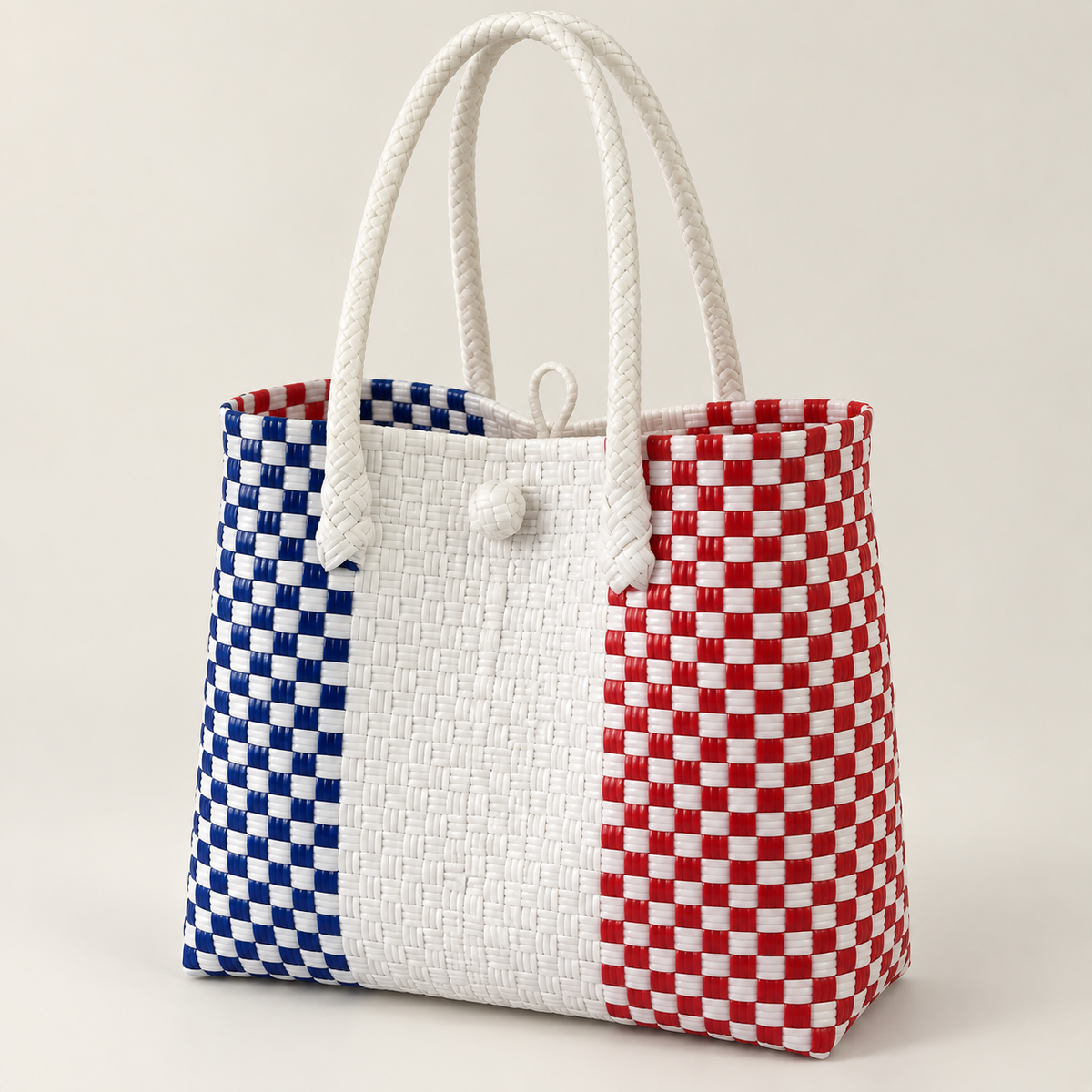 Angled view of The French GalaBag showing its handles, closure and tricolour weave.