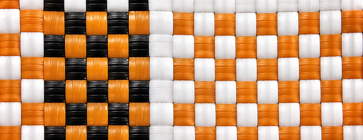 Woven pattern with black, orange, and white squares of the Autumn Gala Bag