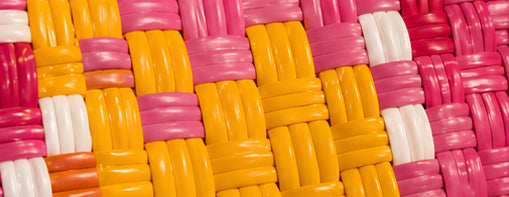 Close-up of the Sunrise Gala Bag woven pattern using 100% recycled plastic.