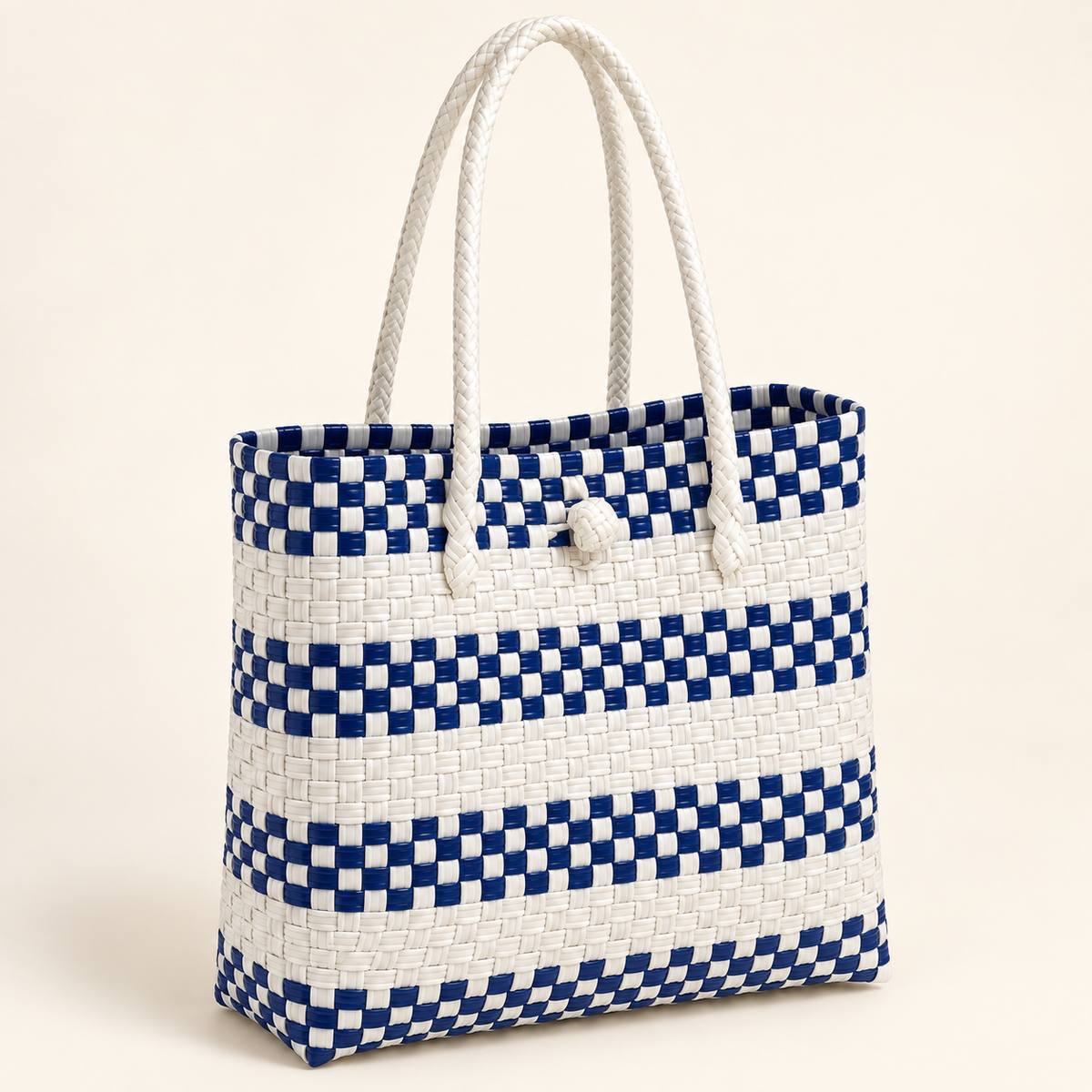 Angled view of The Greek GalaBag showing its handles, closure and blue-and-white weave.
